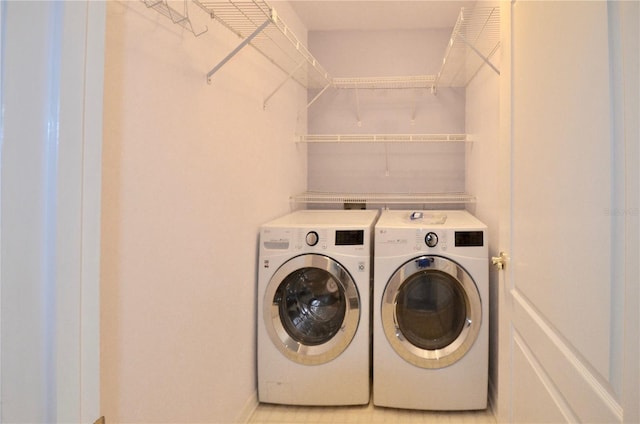 laundry room with separate washer and dryer and laundry area