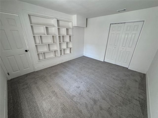 unfurnished bedroom with carpet floors, a closet, visible vents, and baseboards