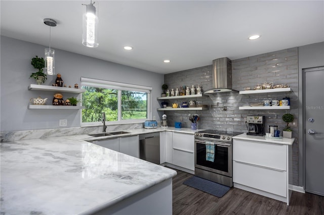 kitchen featuring open shelves, stainless steel appliances, wall chimney exhaust hood, and a sink