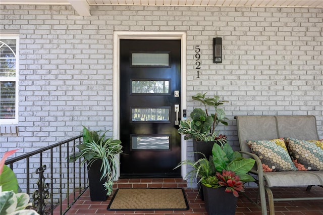 property entrance with brick siding