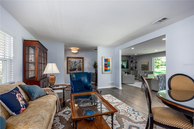 living area featuring recessed lighting, wood finished floors, visible vents, and baseboards