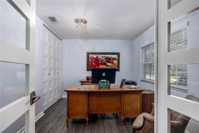 home office featuring dark wood finished floors, an inviting chandelier, and visible vents