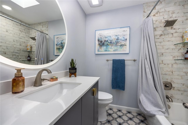 bathroom featuring baseboards, toilet, tile patterned floors, shower / bath combination with curtain, and vanity