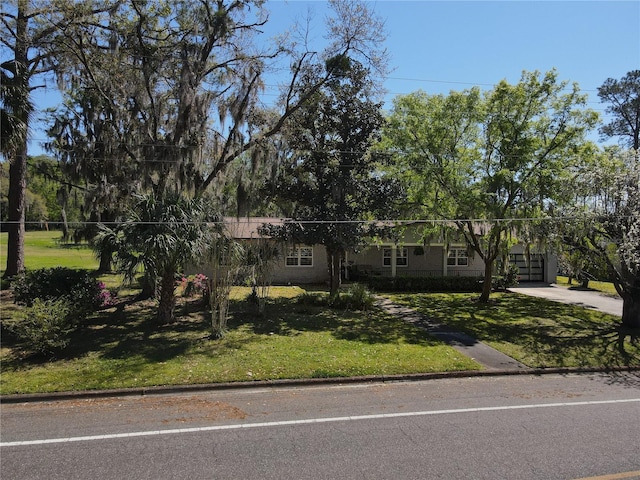 view of front of home featuring a front lawn and concrete driveway