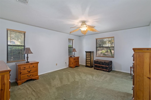 sitting room featuring ceiling fan, carpet floors, plenty of natural light, and baseboards