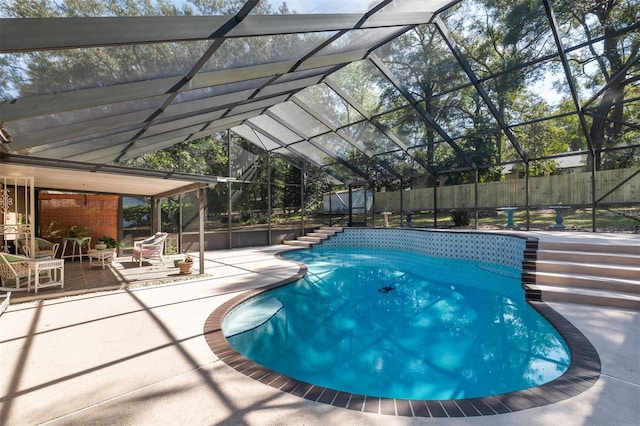 view of swimming pool with fence private yard, glass enclosure, a fenced in pool, and a patio