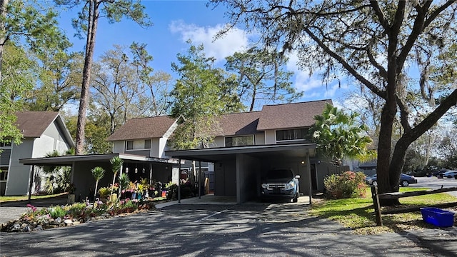 view of front of house featuring driveway and a carport