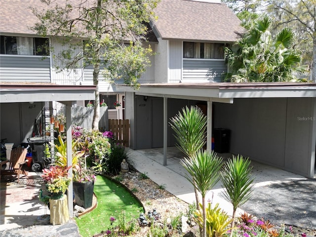 view of front of property with a shingled roof and fence