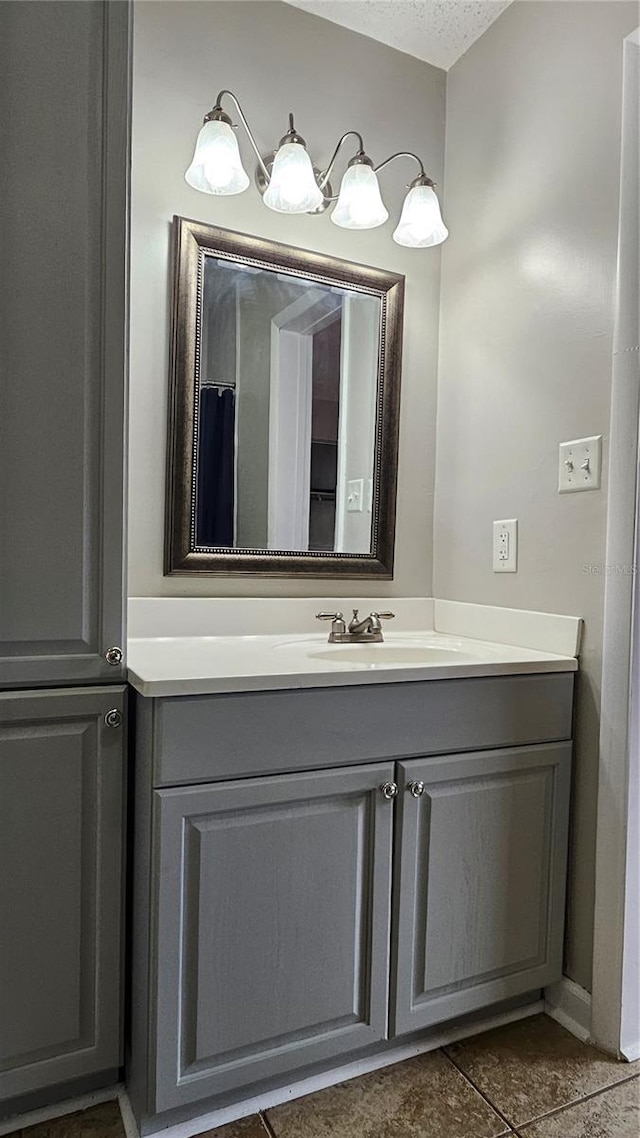 bathroom featuring a textured ceiling and vanity