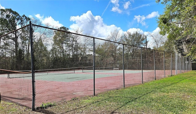 view of sport court featuring fence