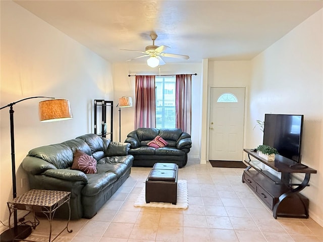 living room with a ceiling fan and light tile patterned flooring