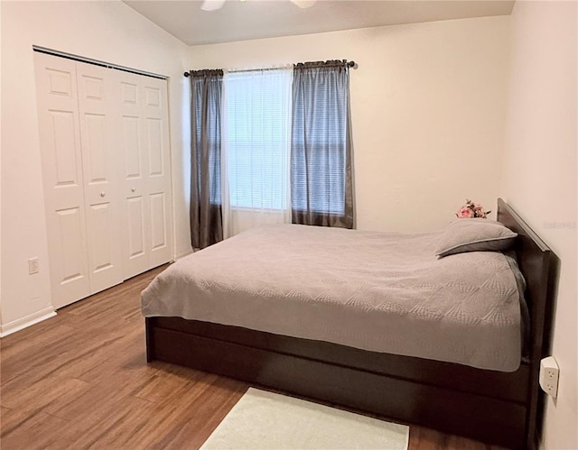 bedroom with a closet, baseboards, and wood finished floors