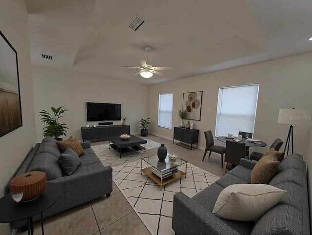 living room featuring ceiling fan, visible vents, baseboards, and light tile patterned flooring