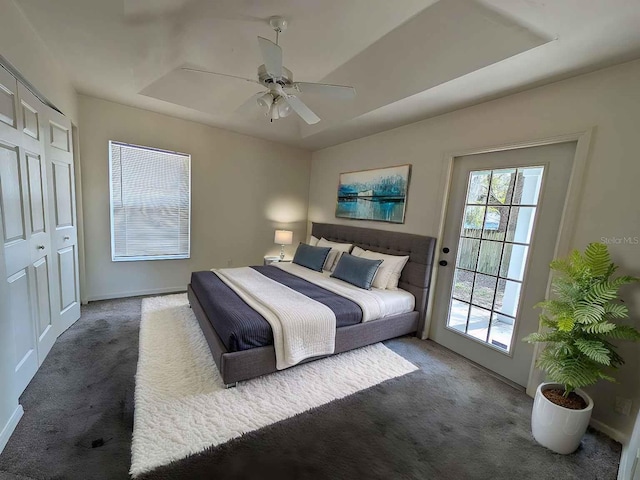 carpeted bedroom with a ceiling fan and baseboards