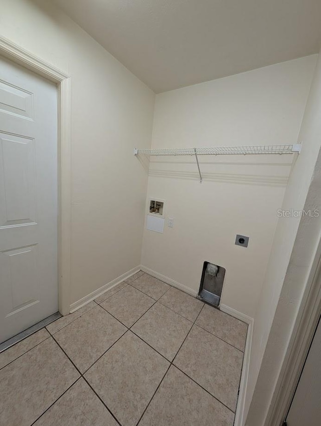 laundry area featuring light tile patterned floors, hookup for an electric dryer, laundry area, washer hookup, and baseboards