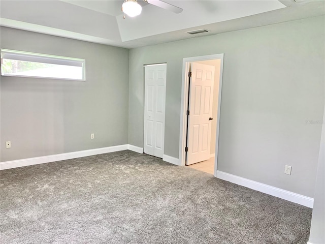 unfurnished bedroom featuring carpet floors, visible vents, ceiling fan, and baseboards