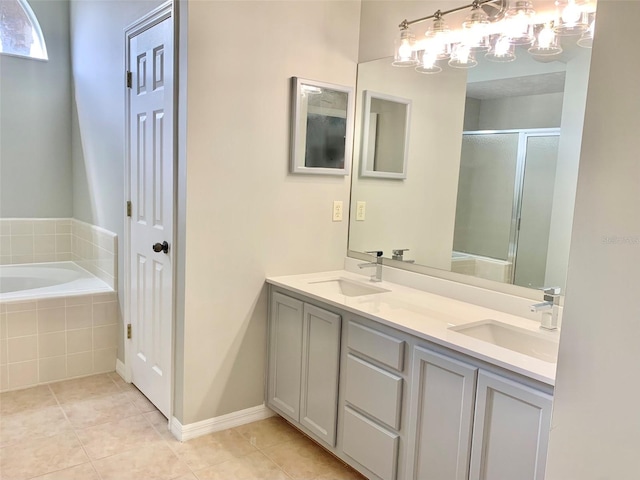 full bathroom featuring a garden tub, a shower stall, and a sink