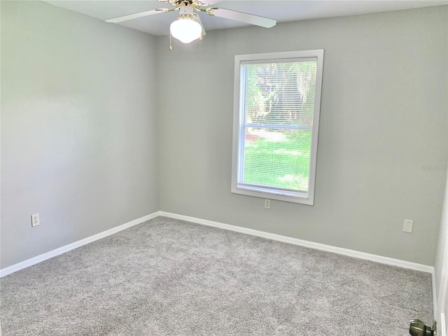 unfurnished room with carpet, baseboards, and ceiling fan