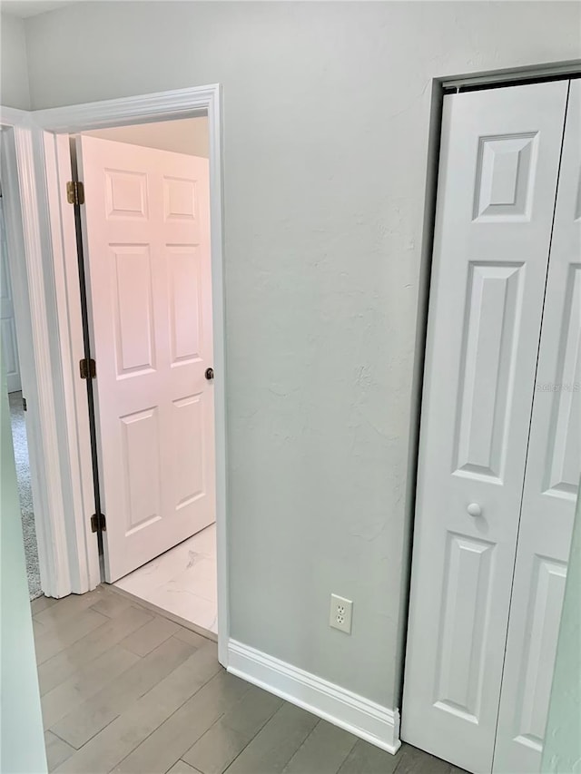 unfurnished bedroom featuring wood finished floors and baseboards