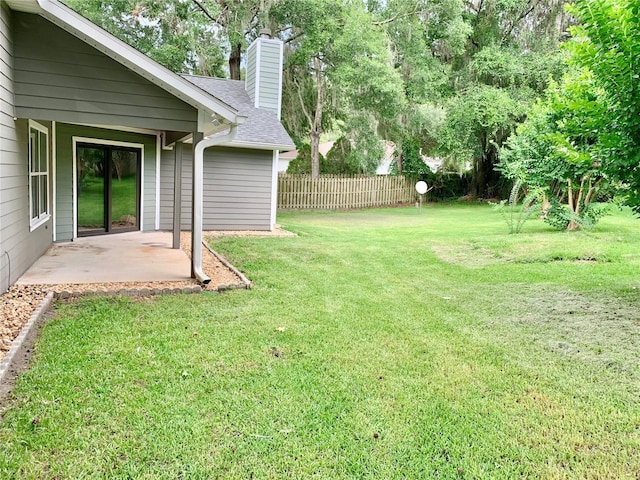 view of yard with fence and a patio