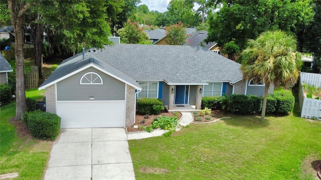 single story home with fence, a front lawn, concrete driveway, and brick siding