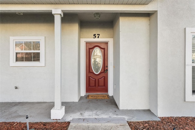 view of exterior entry with stucco siding