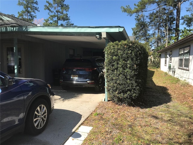 view of property exterior featuring a carport and concrete driveway