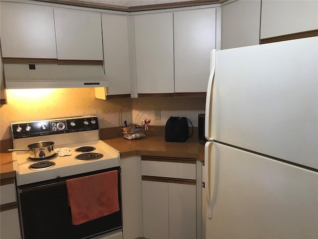 kitchen with freestanding refrigerator, white cabinets, range with electric stovetop, and exhaust hood