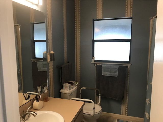 full bath featuring vanity and toilet