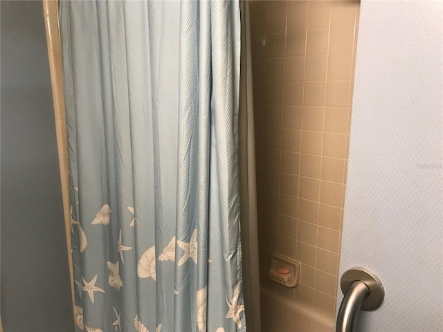 interior details featuring a shower with curtain