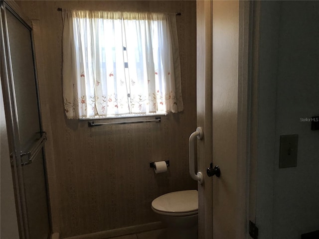 full bath with a shower with door and toilet