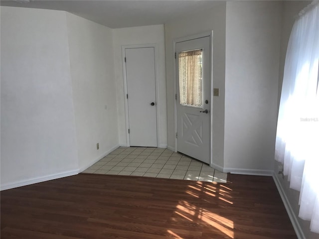 entrance foyer with light wood-type flooring and baseboards