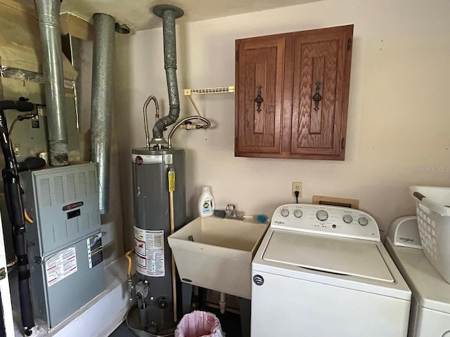 laundry room with water heater, separate washer and dryer, laundry area, and a sink