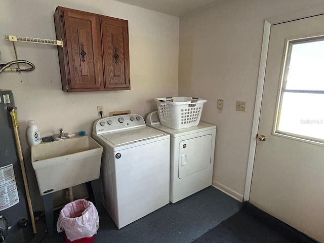 laundry room with a sink, water heater, cabinet space, and washer and clothes dryer