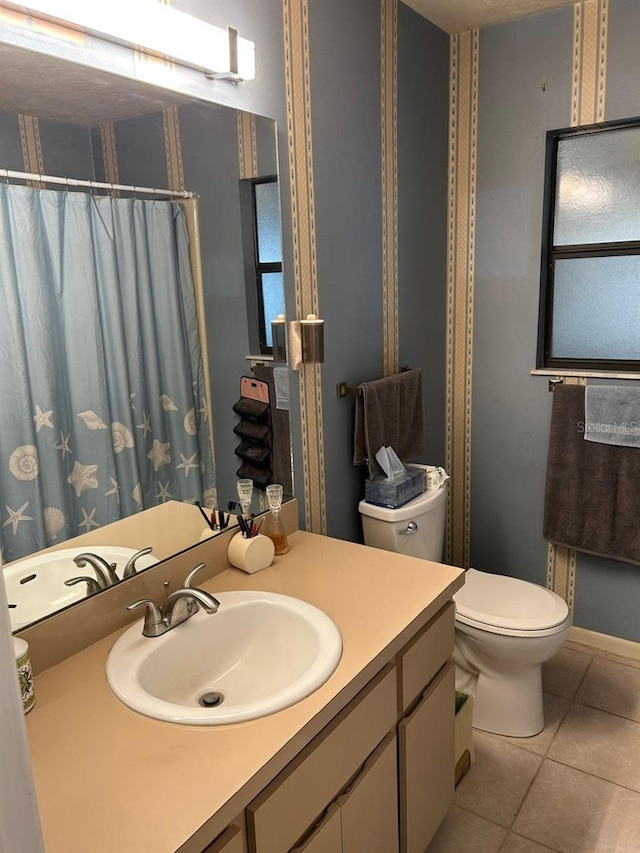 full bath with tile patterned flooring, curtained shower, vanity, and toilet