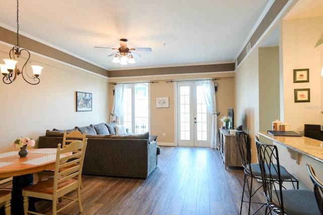 living room with french doors, ornamental molding, wood finished floors, and visible vents