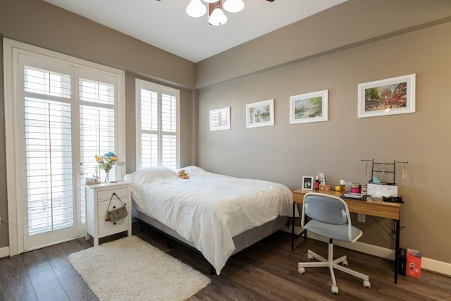 bedroom featuring dark wood finished floors and baseboards