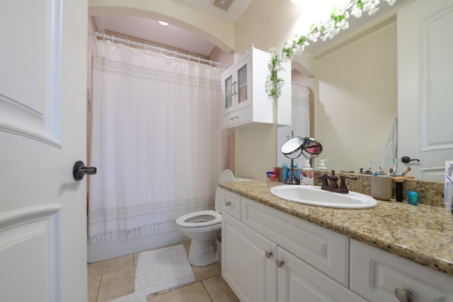 bathroom with toilet, vanity, visible vents, and tile patterned floors