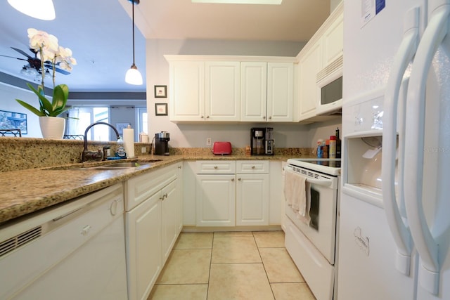 kitchen featuring white appliances, light tile patterned floors, white cabinets, and a sink