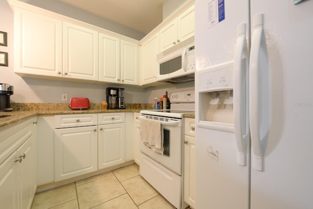 kitchen featuring white appliances, light tile patterned flooring, white cabinetry, and light stone countertops