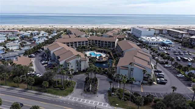 birds eye view of property with a view of the beach and a water view