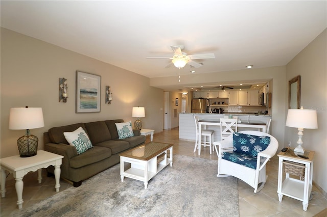 living area featuring a ceiling fan and light tile patterned flooring