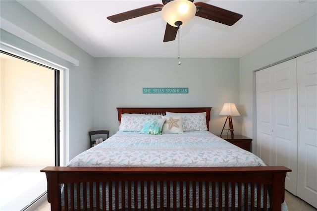 bedroom featuring ceiling fan, multiple windows, and a closet