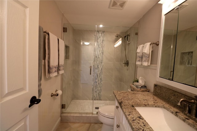 full bathroom featuring toilet, a shower stall, visible vents, and vanity