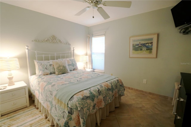 bedroom with ceiling fan, baseboards, and light tile patterned floors