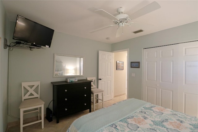 bedroom featuring a ceiling fan, tile patterned flooring, visible vents, and a closet