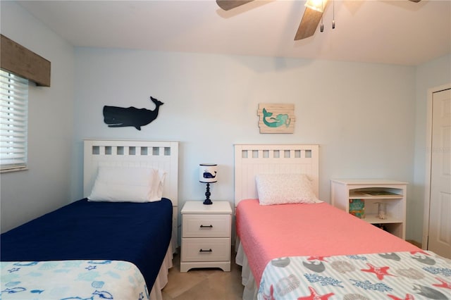 bedroom featuring a ceiling fan and light colored carpet