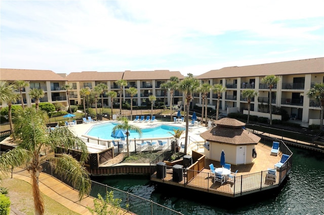 community pool featuring a water view and a patio