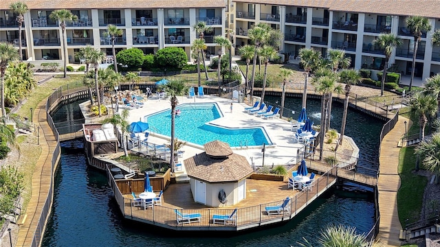 pool with a patio and a water view