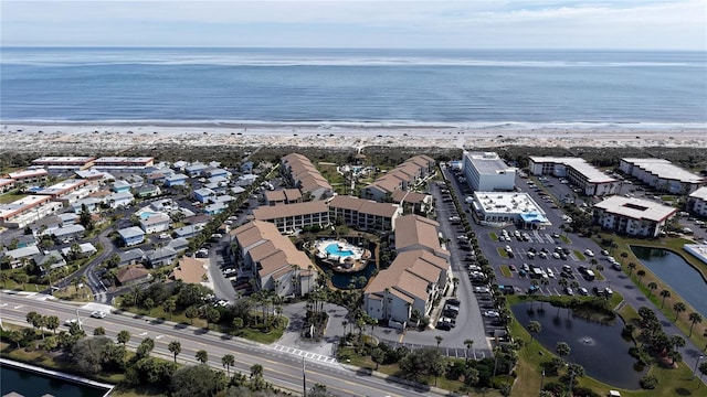 birds eye view of property featuring a beach view and a water view